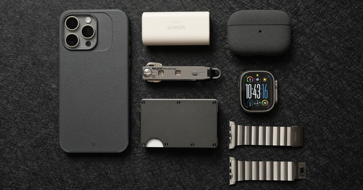 Minimalist everyday carry flat lay: phone, earbuds case, power bank, Keyport Pivot, slim wallet and smartwatch