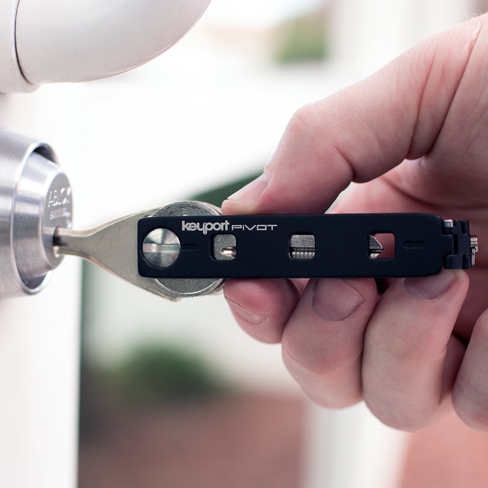 Black Keyport Pivot key organizer keychain opening a door