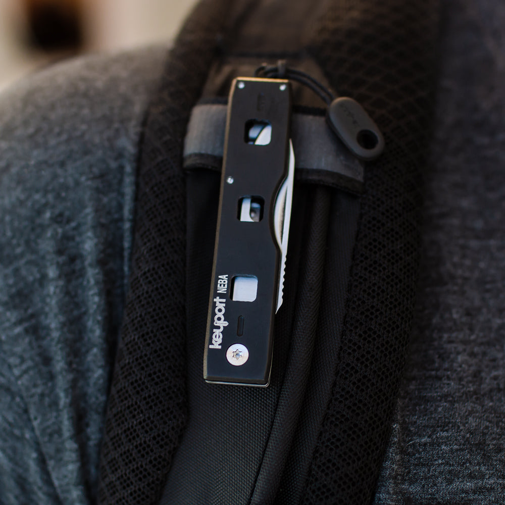 Keyport NEBA Knife Module clipped to molle strap on a backpack