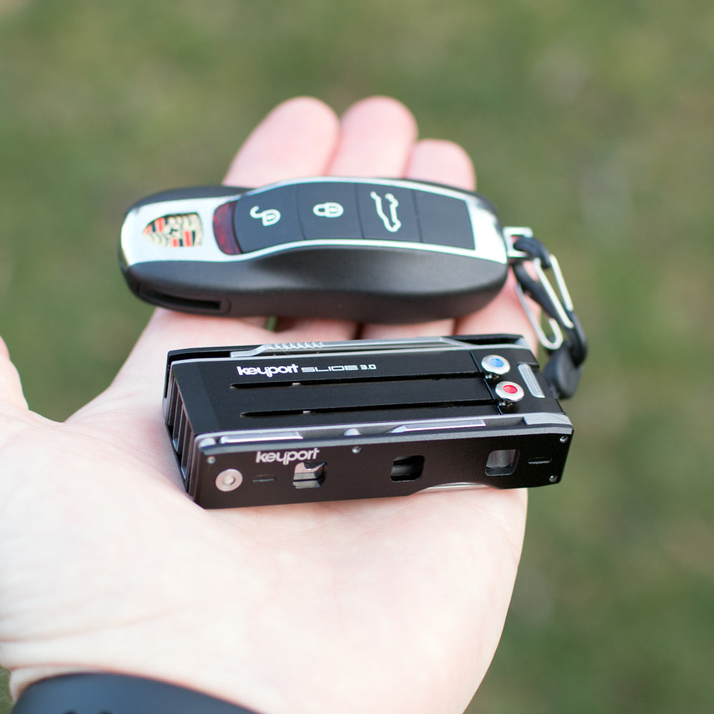 Black 4-port Keyport Slide 3.0 modern key holder with Porsche key fob attached