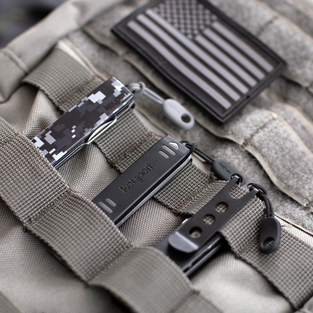 Keyport Anywhere Tools including MOCA 11-In-1 Module, Pocket Flare keychain light module clipped to molle backpack