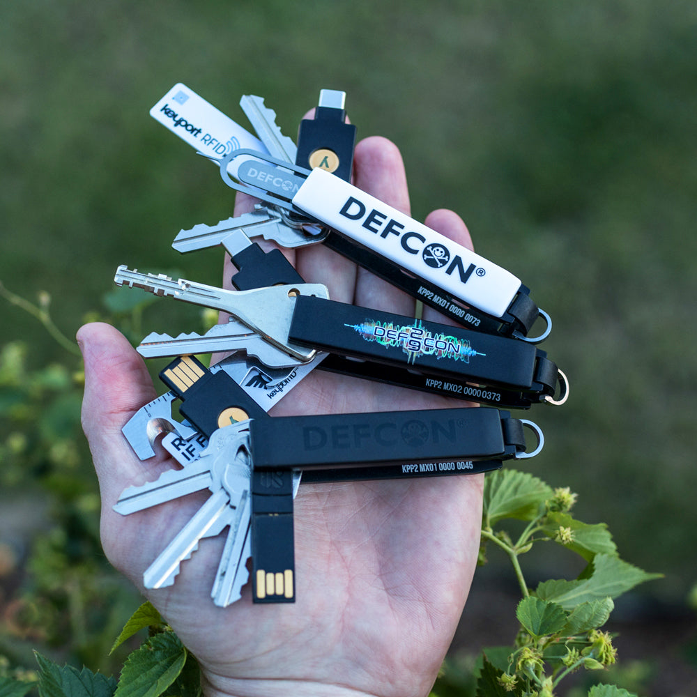 3 DEF CON Keyport Pivot 2.0s with various keys and pocket tools fanned out 