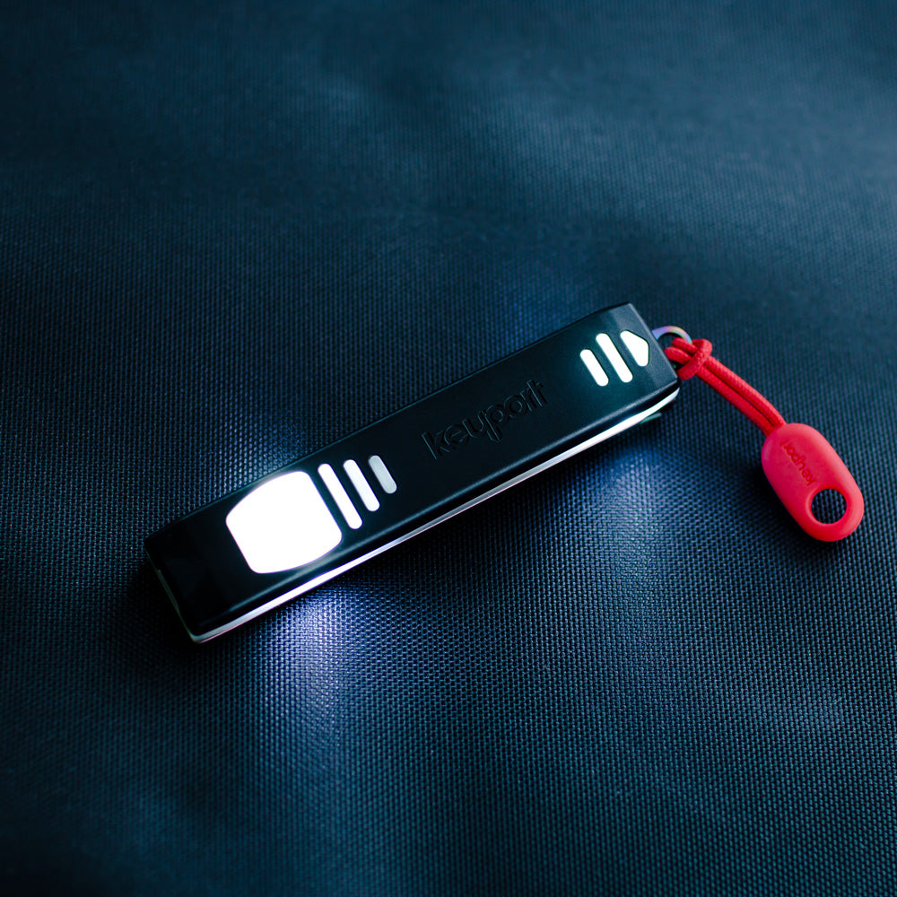 Keyport Pocket Flare 27-lumen rechargeable mini-flashlight with black pocket clip and red ParaPull